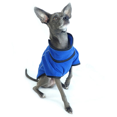 athletic style blue fleece dog jacket front side view on sitting dog