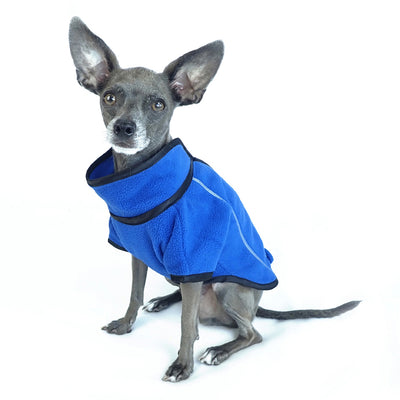 athletic style blue fleece dog jacket front side view on sitting dog